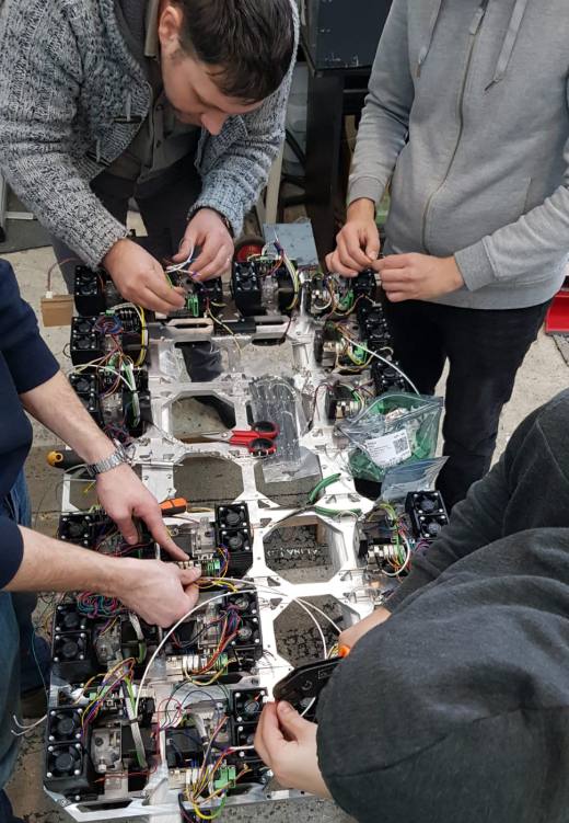 Team assembling 3D-printer modules
